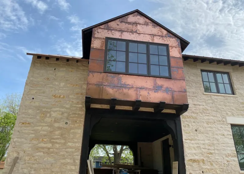 Copper metal panel facade on a stone building for Skylight Installation in Bonita