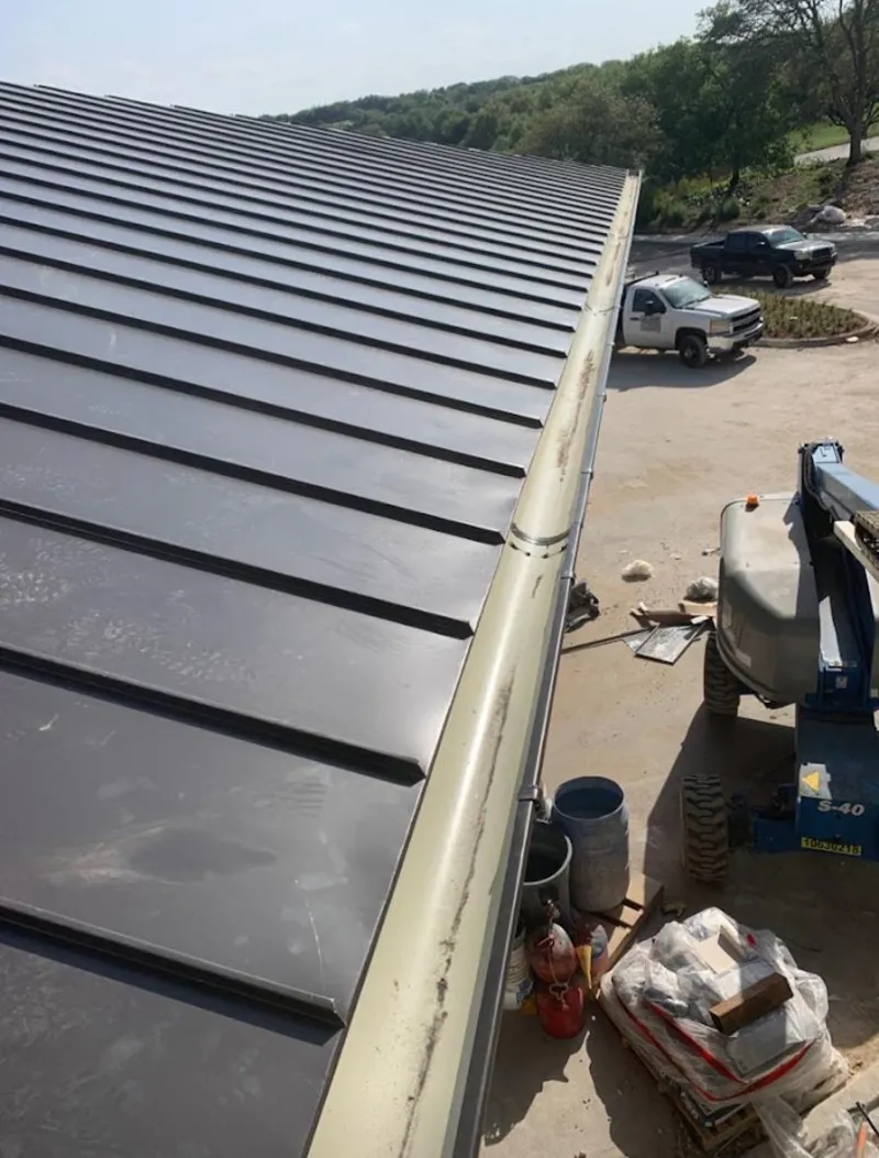 Standing seam panel and gutter detail on a metal roofing jobsite in Bonita